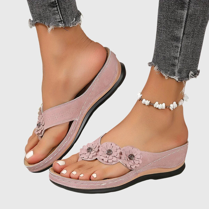 Stylish women's flip flops for summer beach days. Features orthopedic design & comfortable arch support.