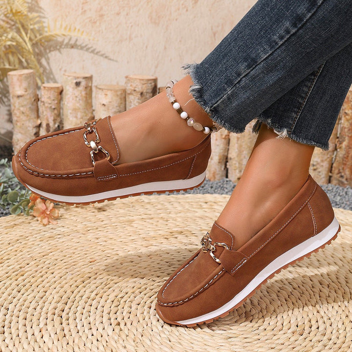 Women's casual loafers, slip-on design with enhanced arch support for walking.