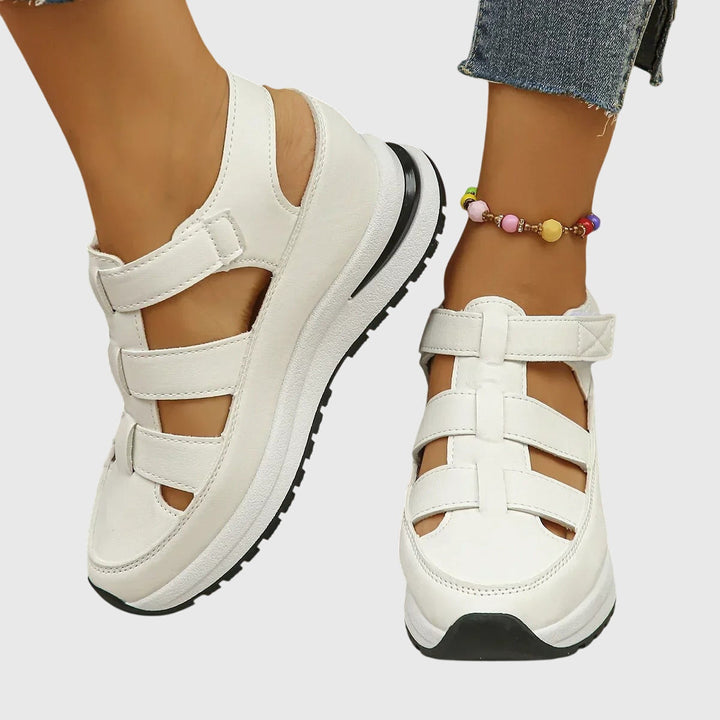 Pair of women's orthopedic summer sandals, adjustable arch support for all-day comfort & relief.