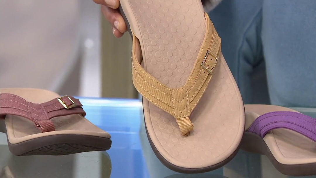 Footwear model wearing women's orthopedic toe sandals, displaying their relaxed fit.