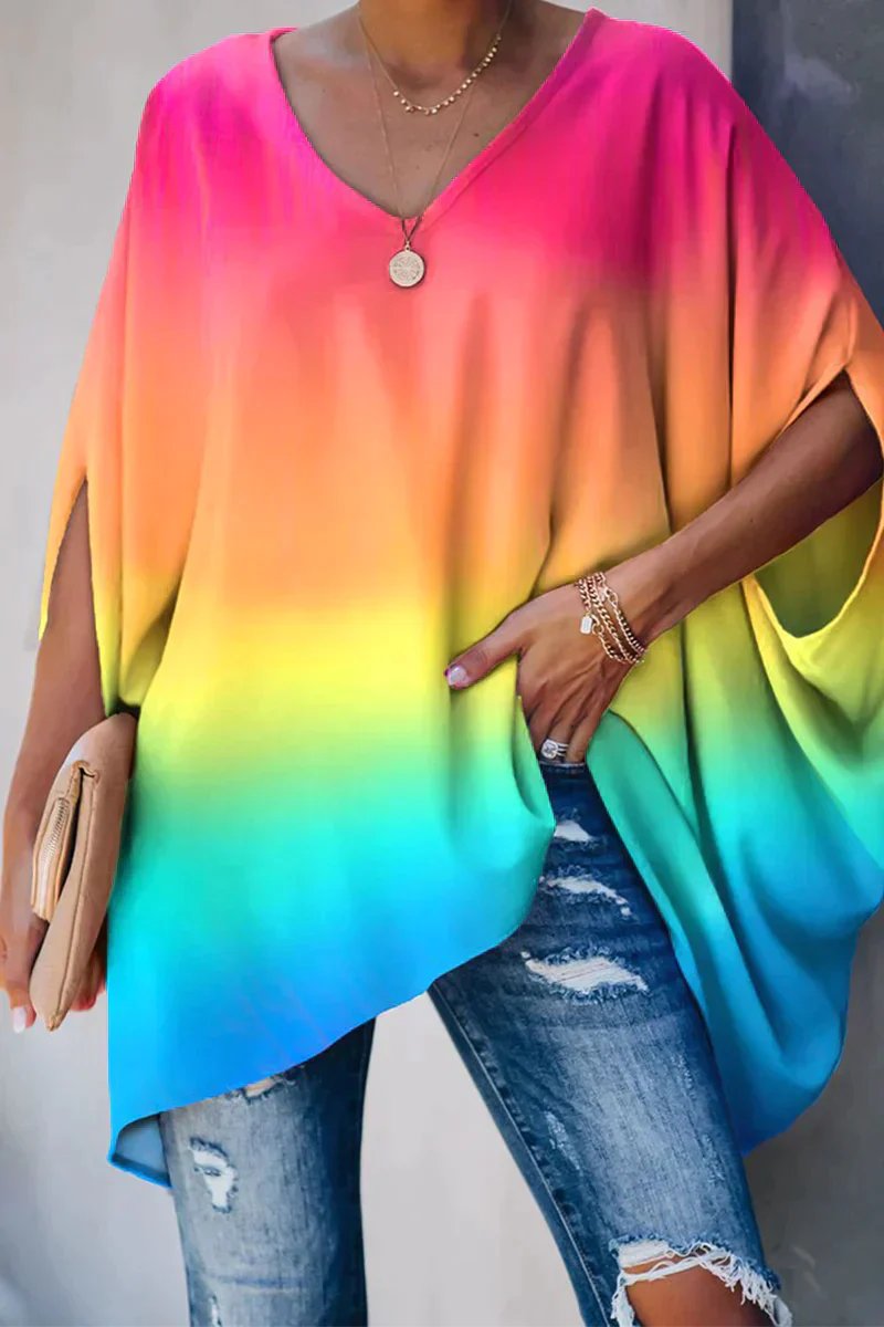 Stylish women's pink oversized tunic with batwing sleeves. Comfortable, relaxed v-neck top for everyday fashion.