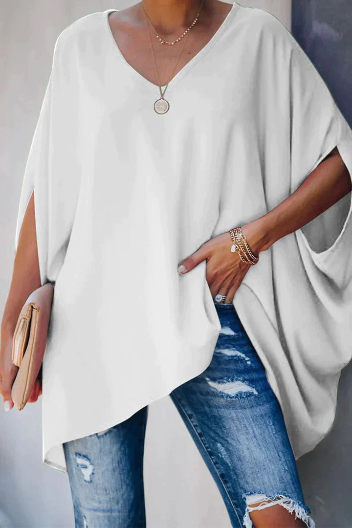 Fashionable women's white oversized tunic top. Features batwing sleeves & v-neck for a relaxed, comfortable fit.