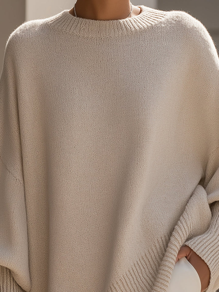 Chic women's oversized poncho sweater, ideal for elegant autumn fashion and comfortable layering.