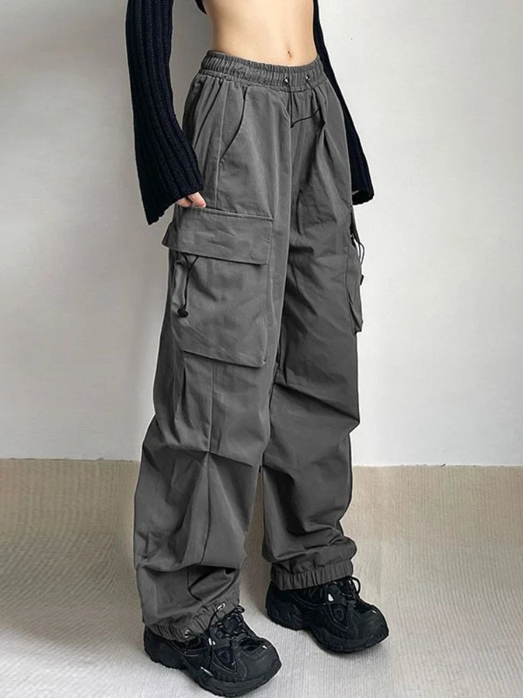Women's oversized cargo pants with wide leg, utility pockets & adjustable waist, perfect for streetwear.
