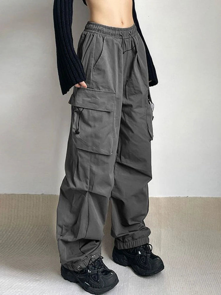 Women's oversized cargo pants with wide leg, utility pockets & adjustable waist, perfect for streetwear.