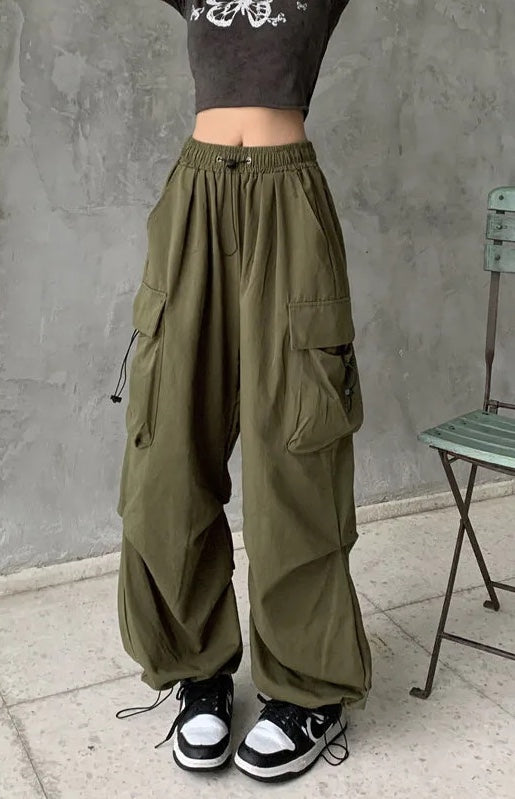 Woman walking in comfortable, wide-leg oversized cargo pants, demonstrating their relaxed fit & versatility.