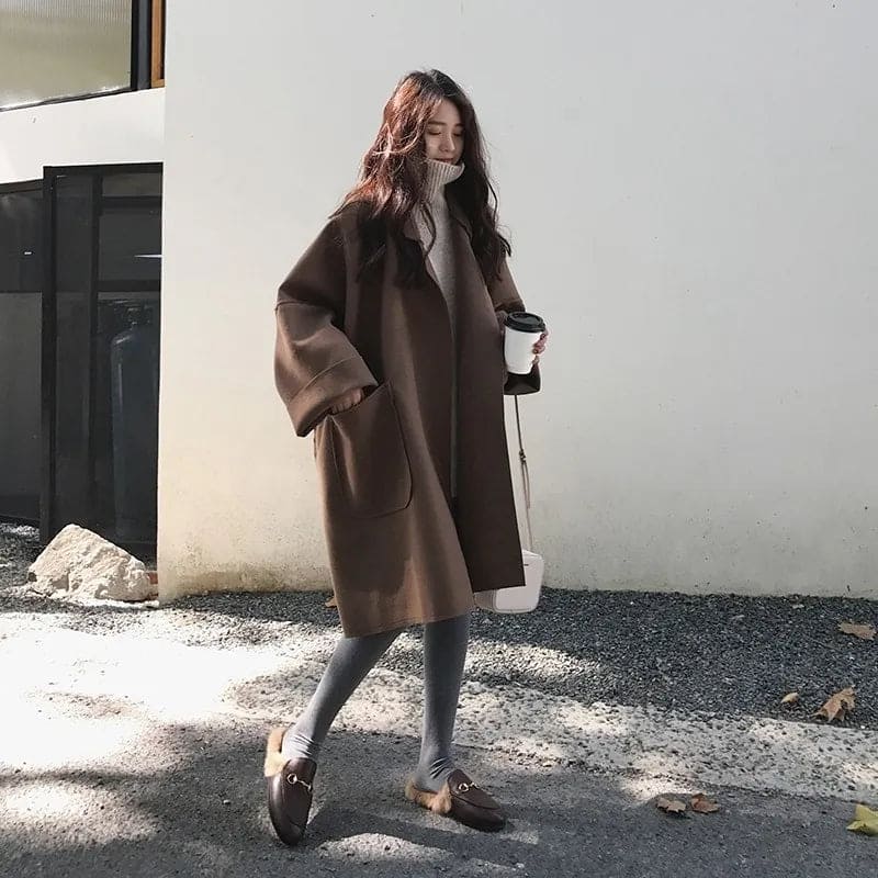 Chic women's oversized trench coat, a classic long double-breasted outerwear piece for elegant seasonal style.