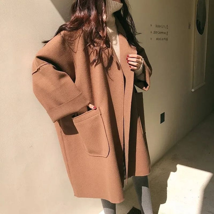Classic women's double-breasted trench coat, an oversized elegant long coat perfect for sophisticated seasonal fashion.