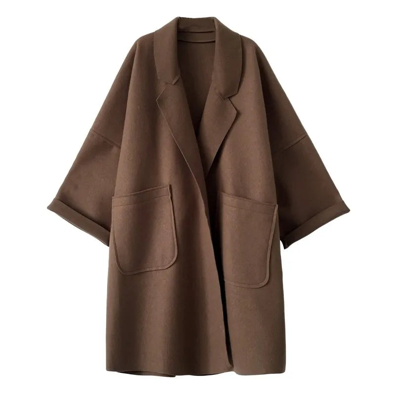 Oversized classic women's trench coat, a long double-breasted design for elegant and chic seasonal outerwear fashion.