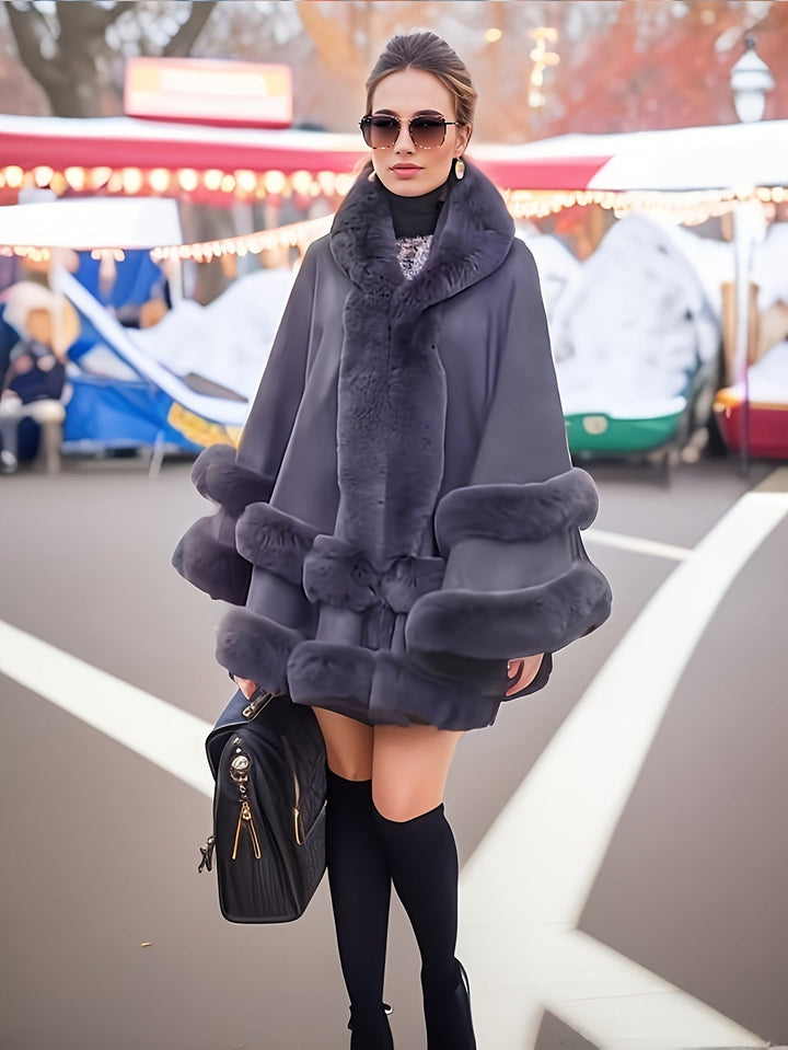 Women's oversized cozy cape coat with hood, perfect for stylish winter fashion and warm outerwear.