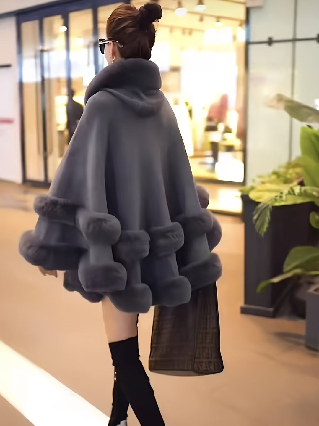 Essential women's oversized hooded cape coat, offering superior warmth and a stylish look for winter.