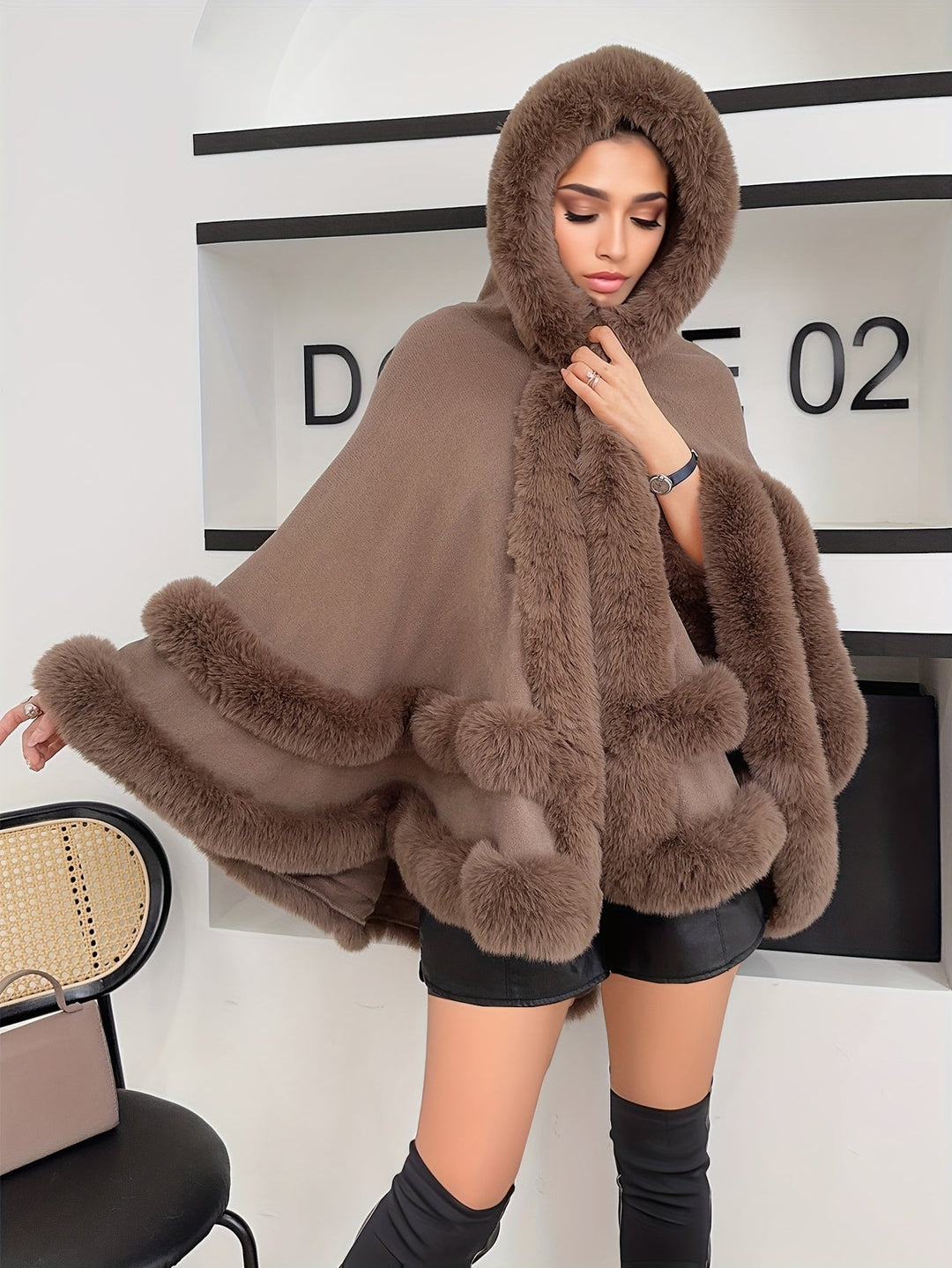 Stylish women's fashion cape jacket, oversized and cozy, a must-have hooded coat for cool weather.
