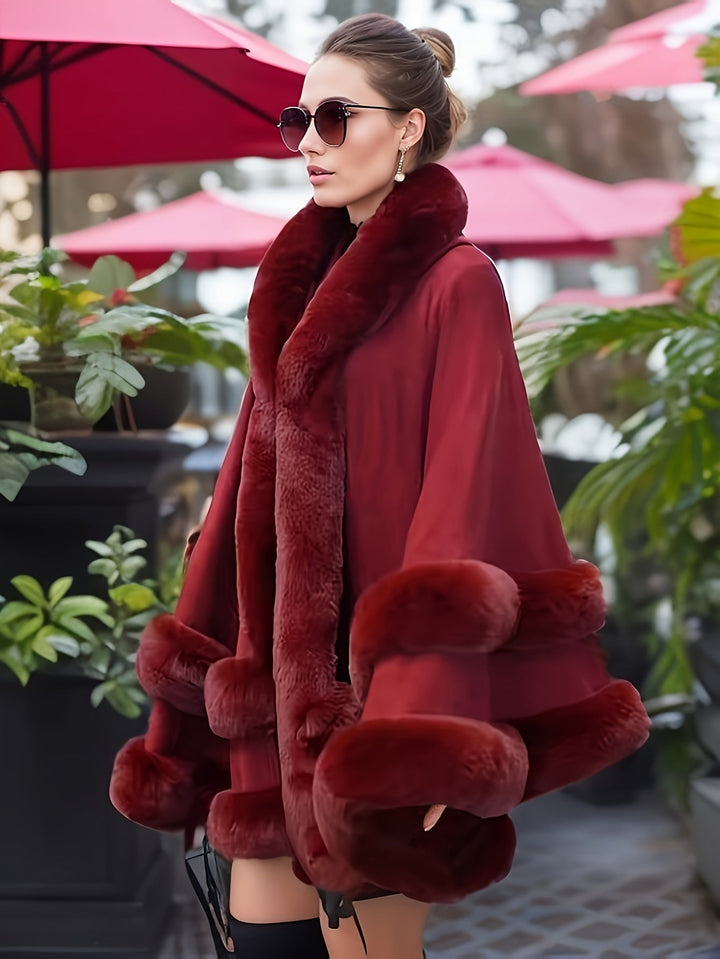 Luxurious women's winter cape coat with hood, oversized fit for elegant and warm outerwear style.