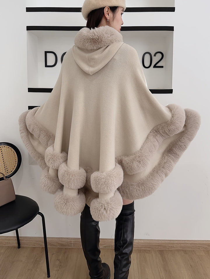 Chic women's hooded cape coat, an oversized and cozy design for modern winter fashion and warmth.