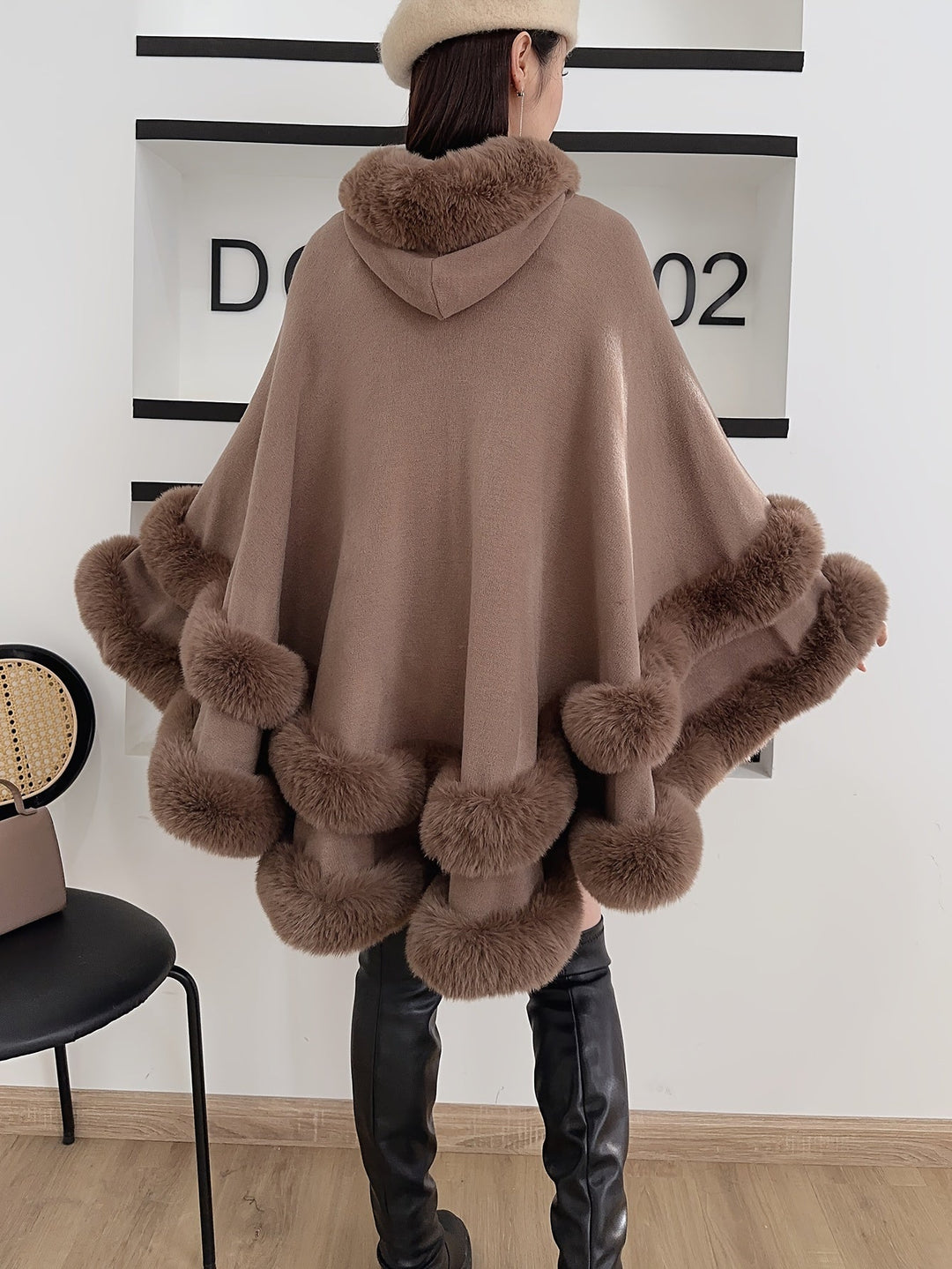 Women's comfortable oversized cape with hood, perfect for cozy wear and elegant autumn fashion trends.