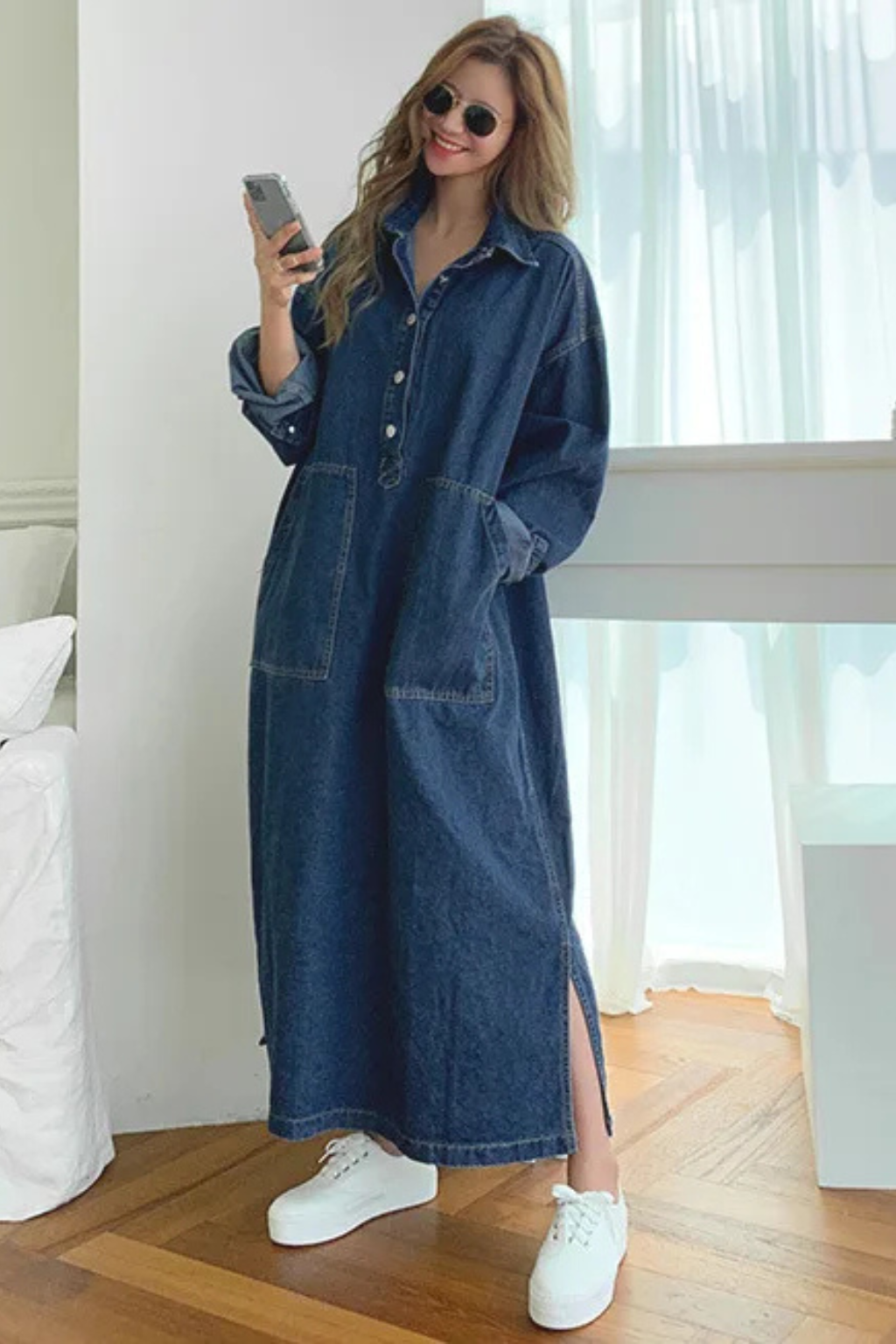 Oversized women's denim maxi shirt dress, a comfortable blue button-front style with practical pockets.