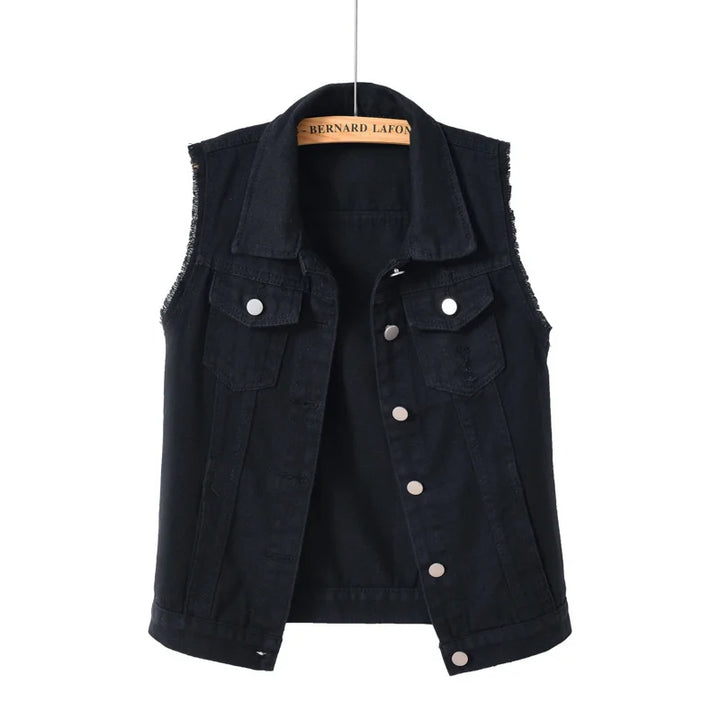 Model wearing a women's oversized distressed denim vest over a casual top.
