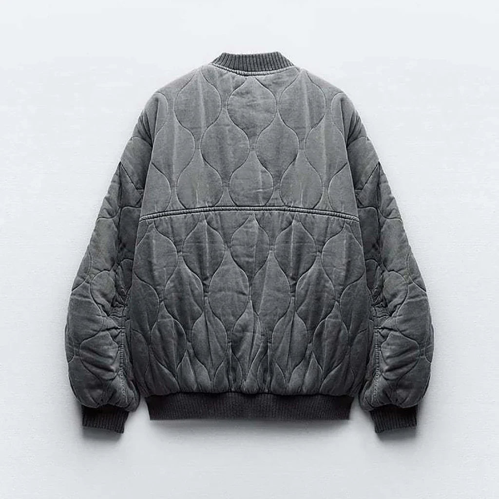 Fashionable women's oversized gray bomber jacket, perfect for a chic and comfortable fall look.