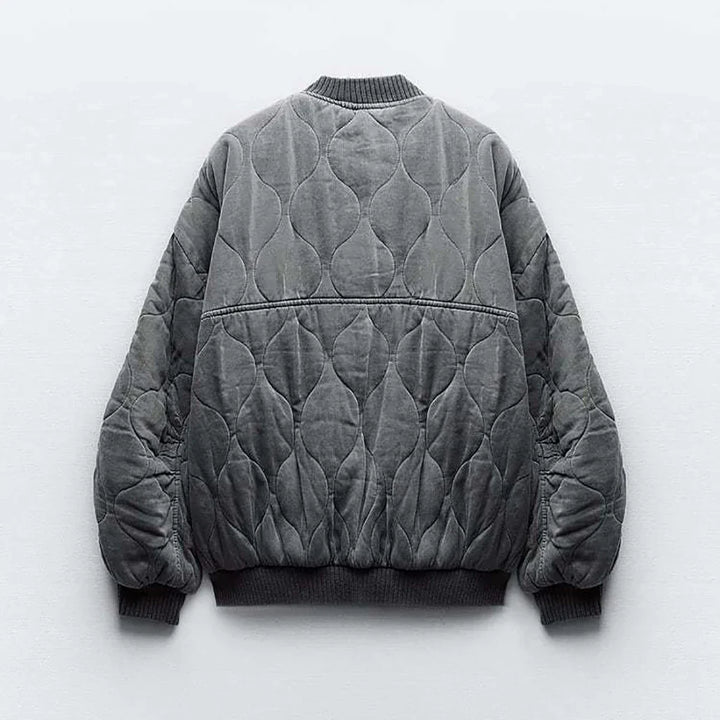 Fashionable women's oversized gray bomber jacket, perfect for a chic and comfortable fall look.