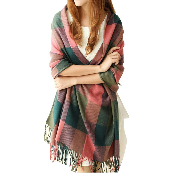 Chic women's oversized plaid scarf, a must-have winter accessory, shown with a stylish coat.