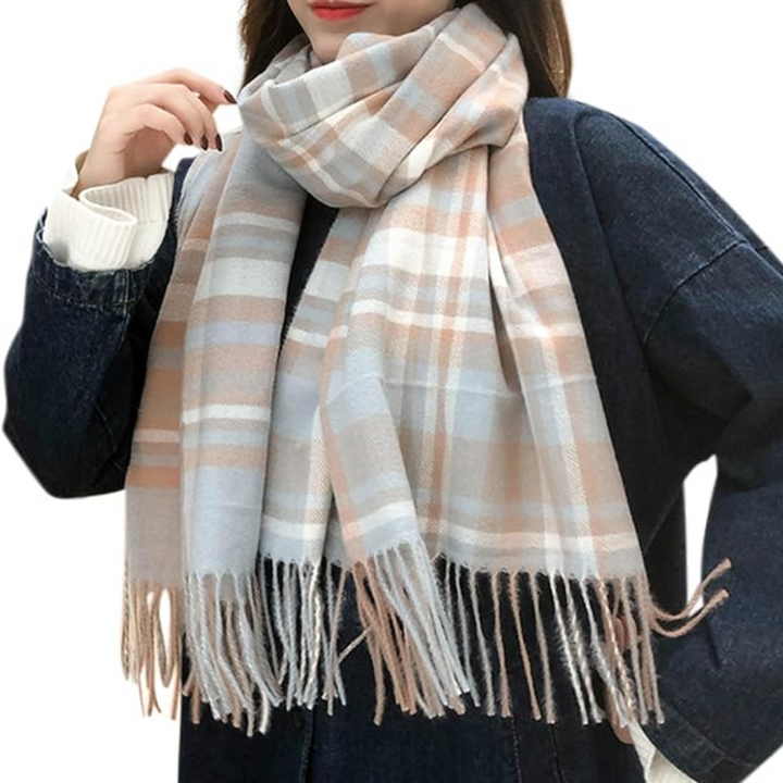 Detail shot of the fringed edges on a women's cozy oversized plaid winter scarf.