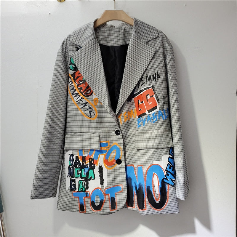 Women's oversized printed blazer with a stylish pattern and pocket, perfect for a chic fashion statement.