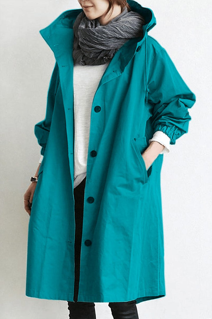 Trendy women's oversized rain parka. Water-resistant trench coat, a versatile outerwear piece for spring & fall.