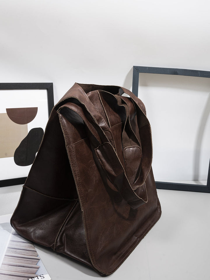 Elegant women's handbag, oversized & practical for travel, with ample space.
