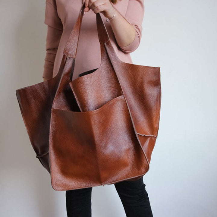 Woman carrying oversized travel bag, demonstrating comfort and style.