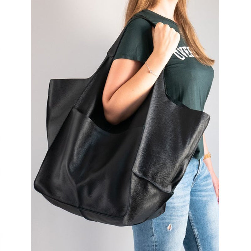 Trendy red oversized weekend bag for women, eye-catching and practical.