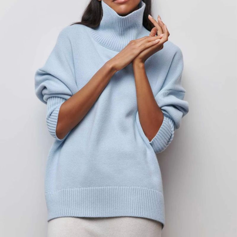 Cozy women's oversized turtleneck sweater, ideal for warm, relaxed fall fashion.