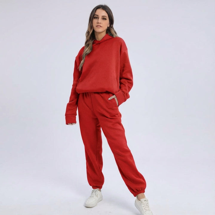Woman relaxing in an oversized two-piece tracksuit set, comfortable loungewear style