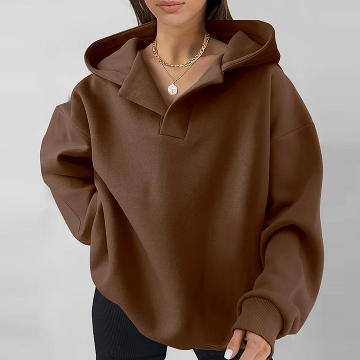 Soft women's oversized v-neck hoodie, a cozy pullover for versatile loungewear or casual long-sleeve fall style.