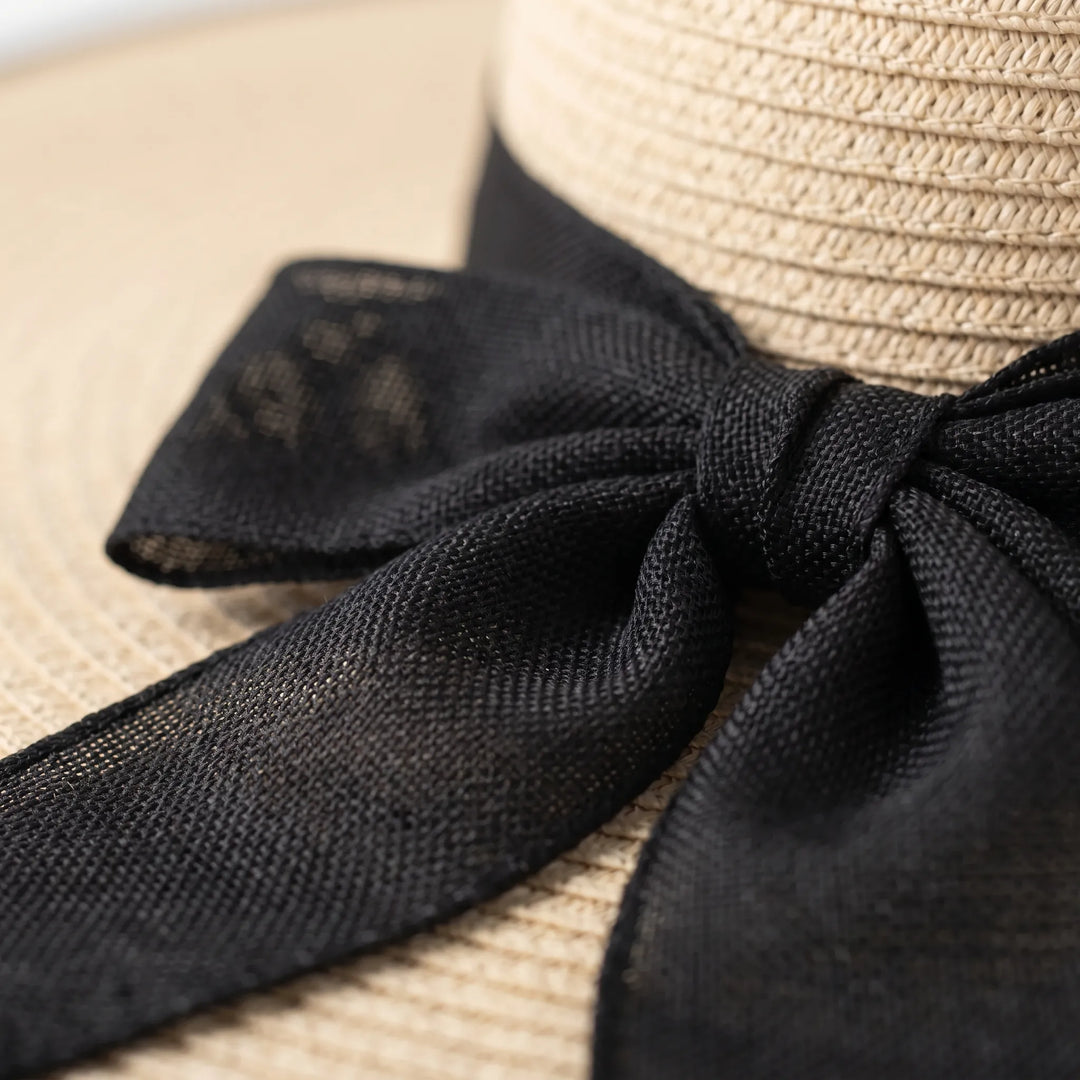 Neutral women's oversized sun hat for beach, travel & maximum sun protection.
