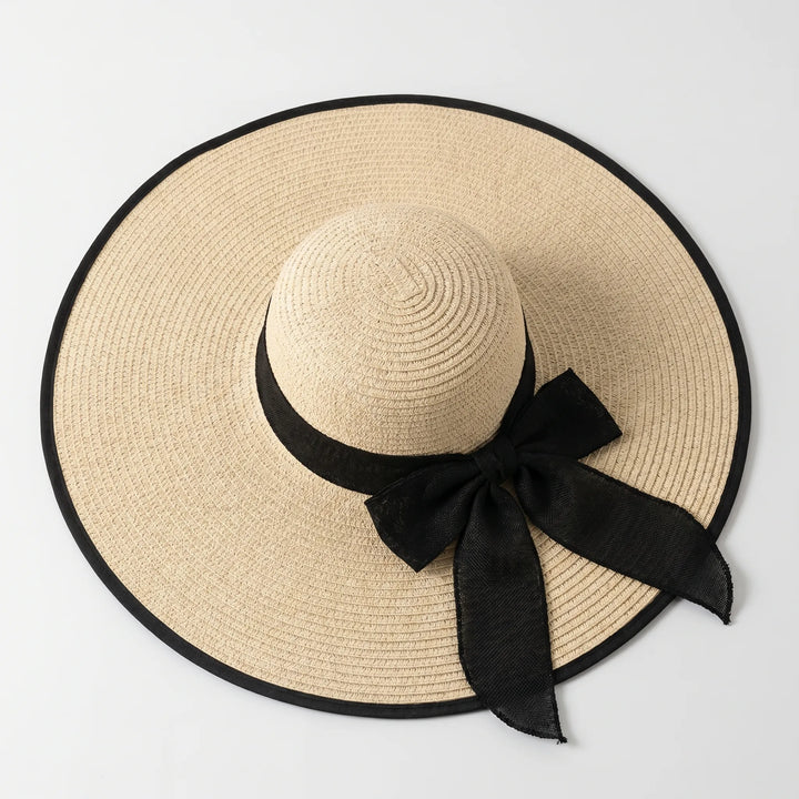 Fashionable wide brim beach hat for women, ideal for vacation & summer style.