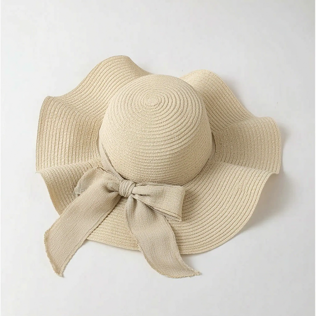 Elegant women's wide brim sun hat with delicate bow, perfect for summer fashion.