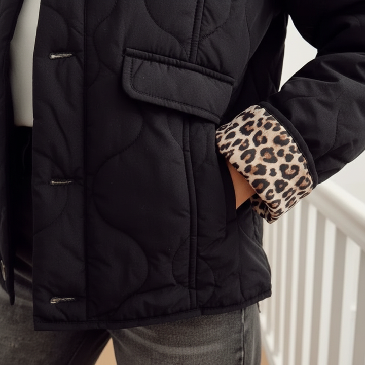 Feminine black padded jacket for women, interior detailed with a subtle leopard lining, ideal for fall