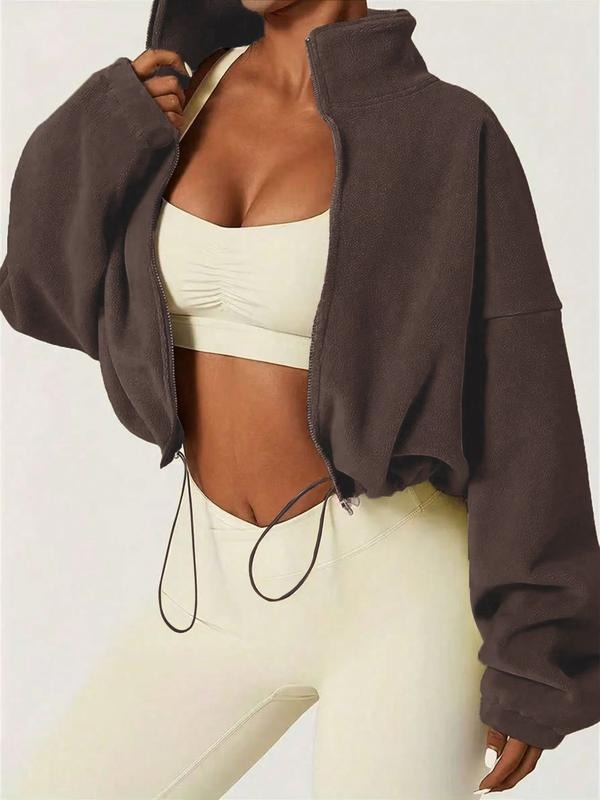Stylish women's cropped zip jacket featuring a high collar, adjustable hem, & comfortable fit. Perfect modern outerwear.