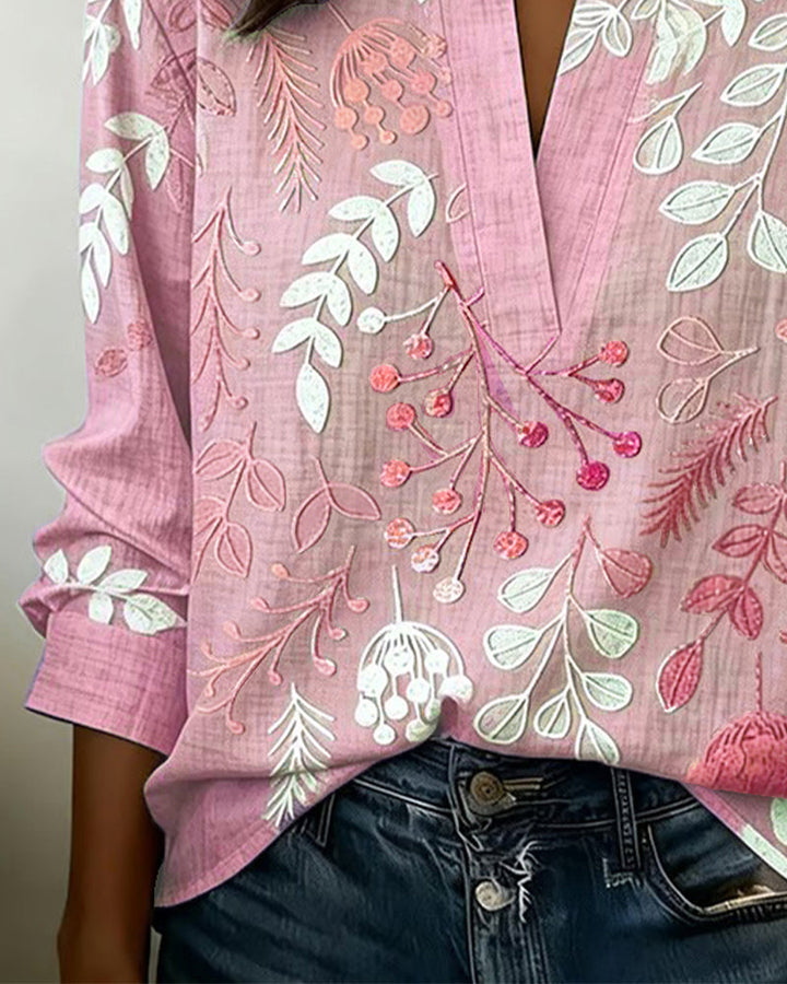 Women's V-neck blouse featuring an all-over pastel floral print, ideal for a fresh spring look.
