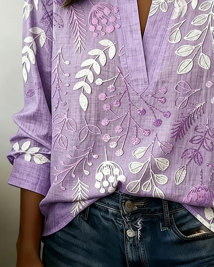Stylish women's V-neck top with a delicate pastel floral print, perfect for casual or workwear.