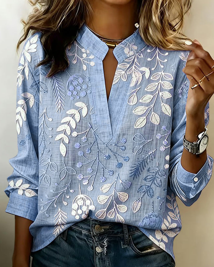 Elegant women's V-neck blouse featuring a soft pastel floral pattern, suitable for office or daily wear.