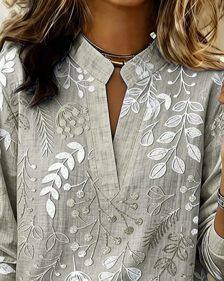 Lightweight women's V-neck blouse with a pretty pastel floral design, essential for summer fashion.