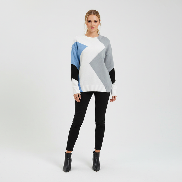 Close-up of women's patchwork knit pullover sweater, showcasing textured design and cotton blend