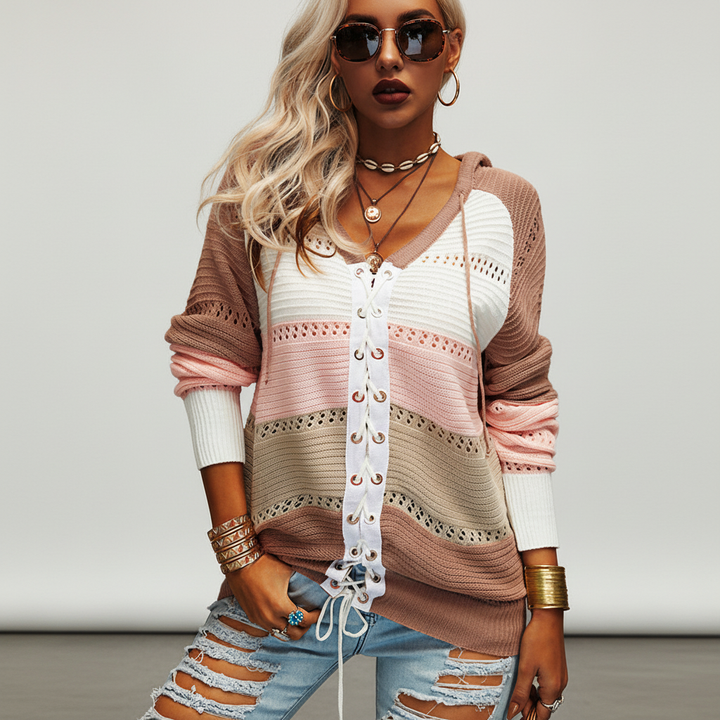Cozy women's pullover sweater featuring striped and patchwork design with front lace-up closure
