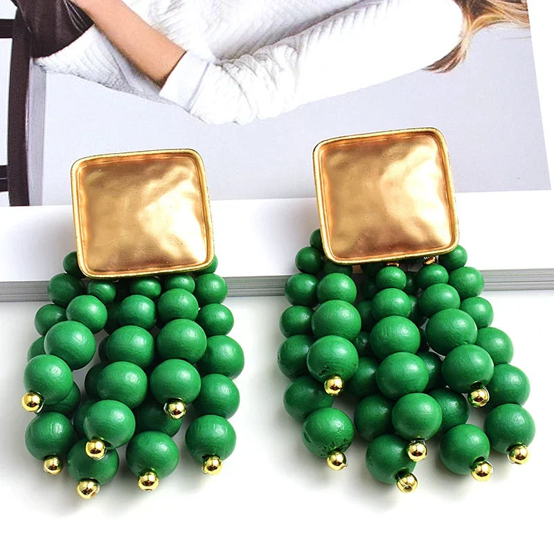 Unique women's wooden pearl-shaped drop earrings. Handmade natural accessory, perfect for boho statement.