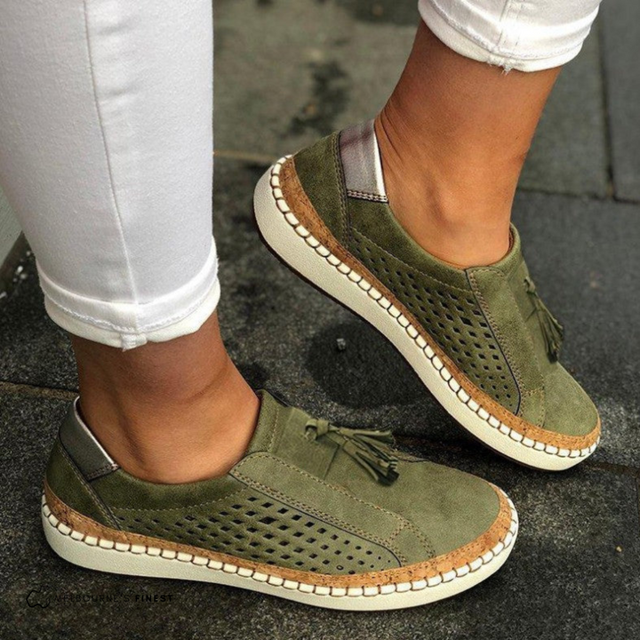 Comfortable women's perforated slip-on flats with stylish tassel accents, perfect for casual summer footwear.