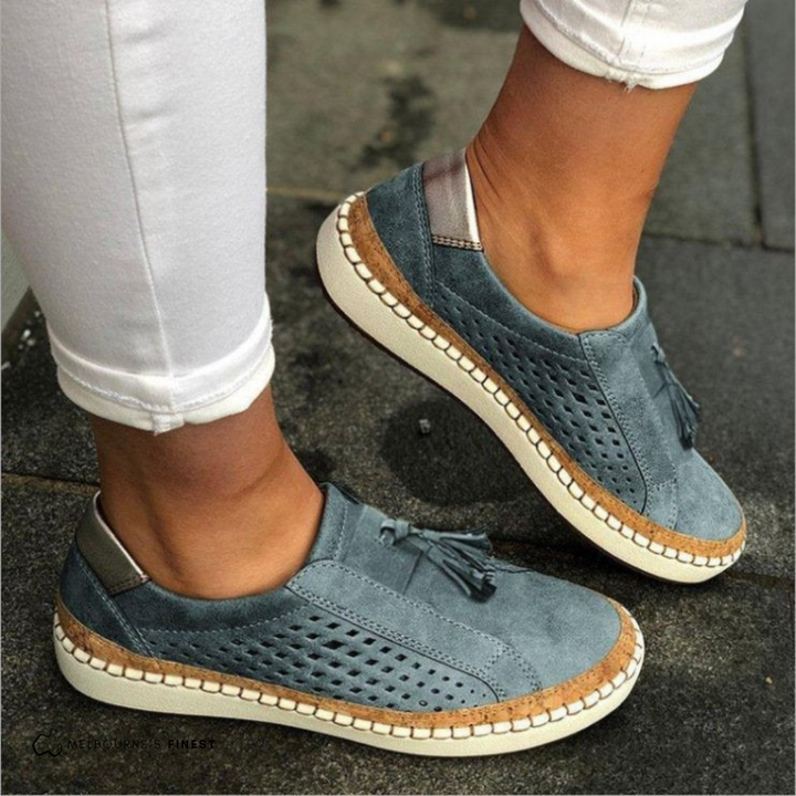 Artisan-inspired women's perforated slip-on loafers with tassel detail, ideal for stylish everyday wear.