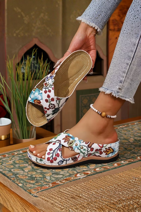 Women's perforated wedge slip-on sandals, designed for comfort and casual summer style.