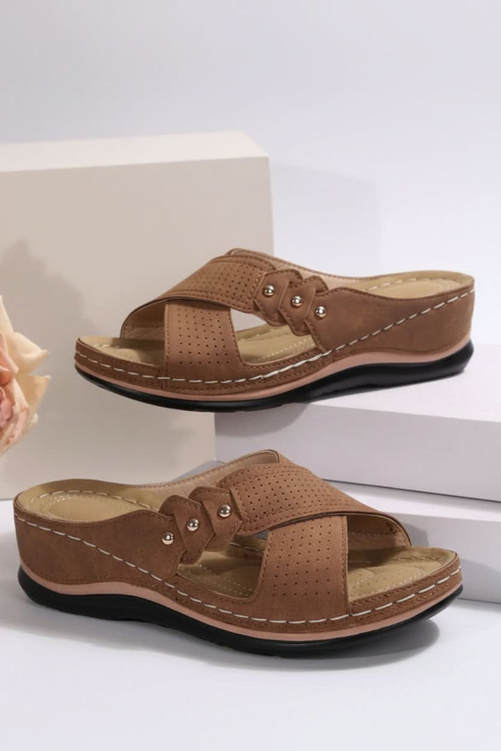 Versatile women's perforated wedge slip-on sandals. Ideal for everyday style, beach trips, and casual summer outings.