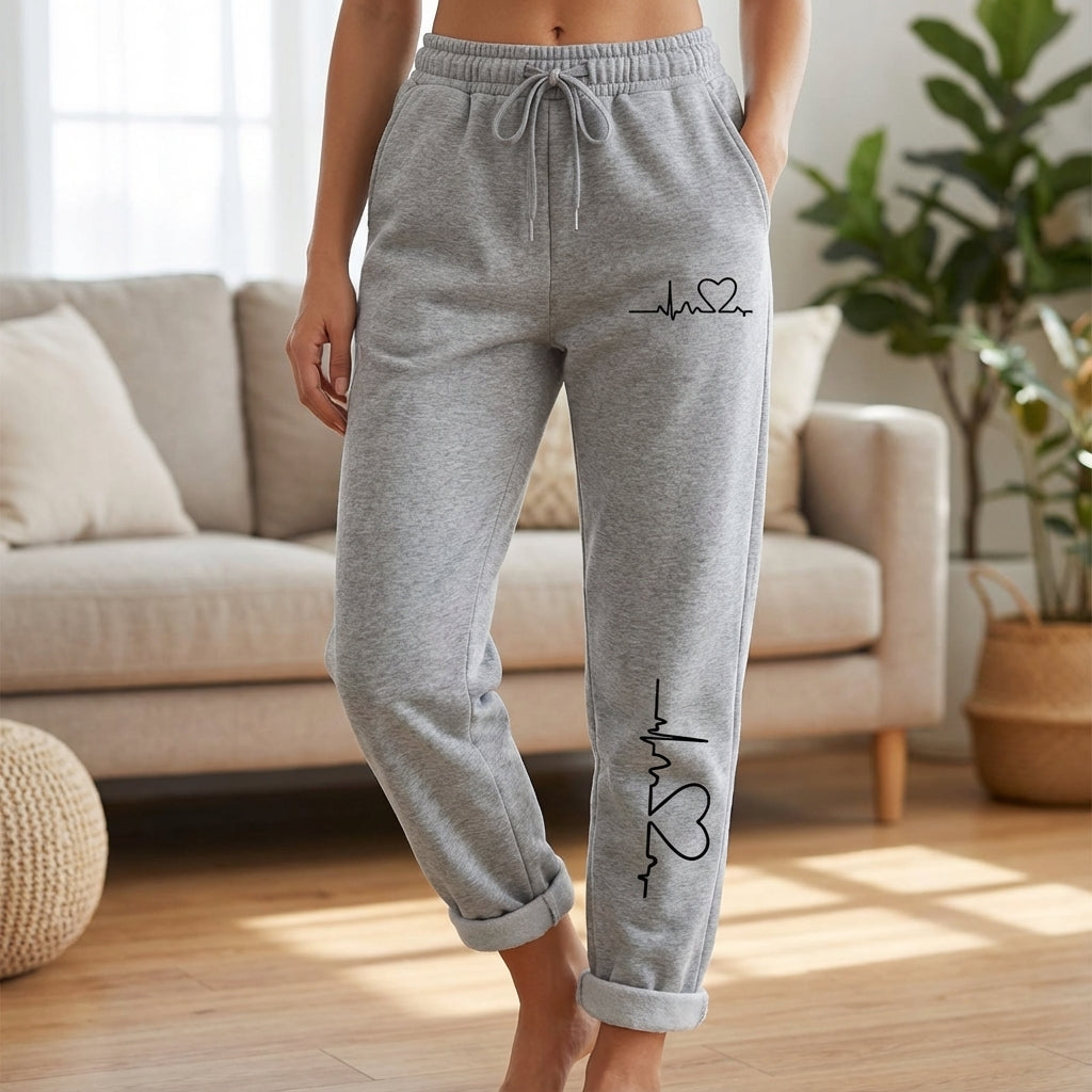 Women's pink cotton relaxed fit sports trousers with white heart motif on leg, comfortable loungewear